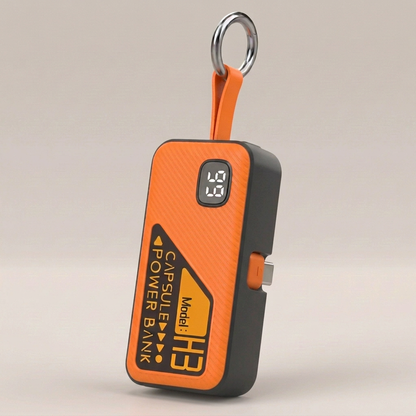 Orange Key Capsule power bank with folded USB-C detail and silver keyring
